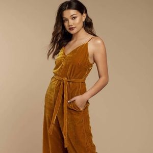 Mustard yellow velvet jumpsuit with fringe detail